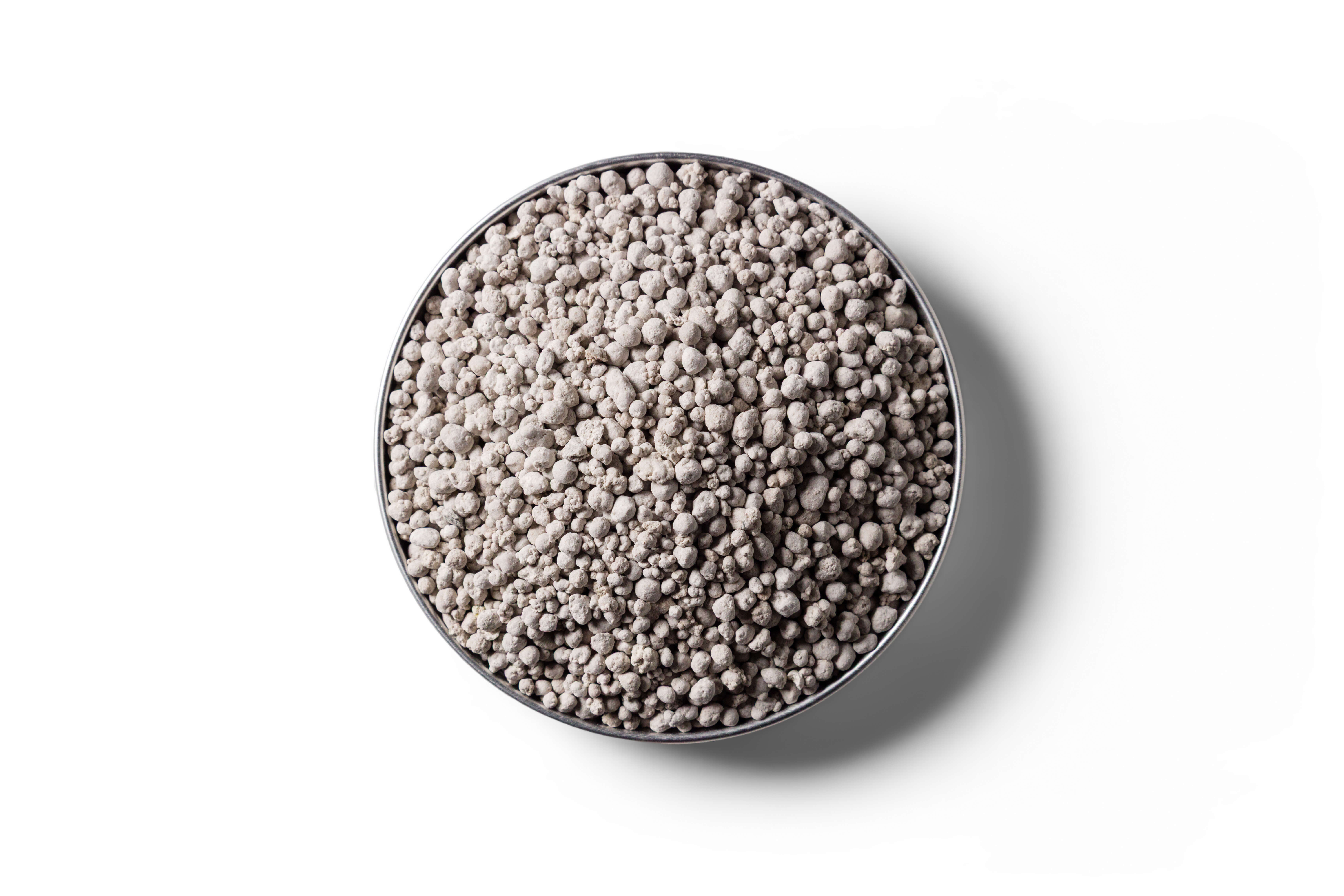 Light grey Superphosphate fertiliser granules in a round dish